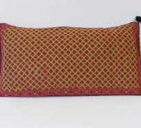 Rectangular, hand-embroidered tribal cushion - strong geometric pattern in green with red background