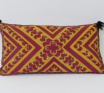 original hand embroidered tribal cushion with intricate geometrical design in red stitching on yellow linen