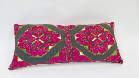 Rectangular, hand-embroidered cushion with bold design - green and pink on a black background