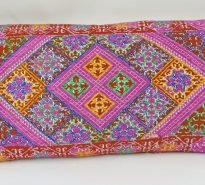 Rectangular, hand-embroidered cushion - mainly pink with multi-coloured (red/green/yellow) squares